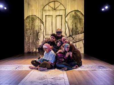 People huddled together sitting on the floor