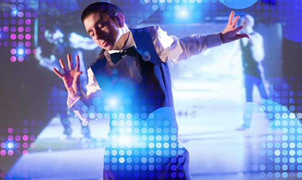 A man in a suit dancing