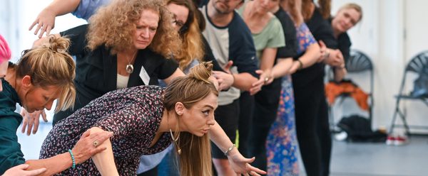 creative insights 2025 participants line up in a movement exercise