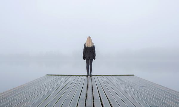 A person looking onto a lake.