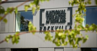 A grey building with large windows