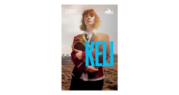 Image of KELI Playtext, featuring Liberty Black. She is wearing a red blazer and holds a Brass musical instrument