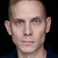 Simon Donaldson gazes intently at the camera. A faint smile can be seen at this lips.