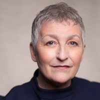 Blythe Duff smiles kindly at the camera. She wears a navy blue jumper.