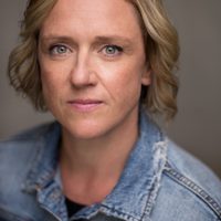 Lesley has blonde hair and blue eyes, she wears a denim jacket
