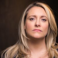 Louise McCarthy looks at the camera, she has blonde hair and wears a black top.