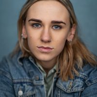 Actress Madeline Grieve looks at the camera. She has blonde hair and wears a denim jacket.