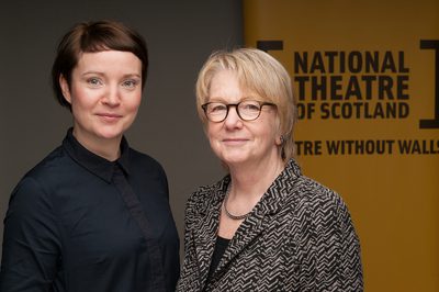 Jackie and Seona standing in front of a yellow NTS sign