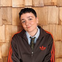 Nay wears a shirt and a trackie zipper.