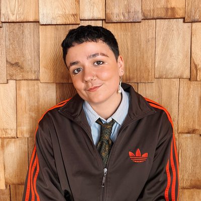 Nay wears a shirt and a trackie zipper.