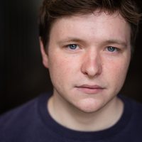 Ryan J Mackay gazes softly at the camera