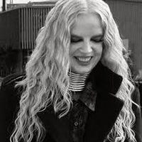Black and white image of Shirley she smiles and has longish blonde hair