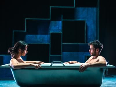 Adam Kashmiry and Yasmin Al Khudhairi face each other in a full bathtub