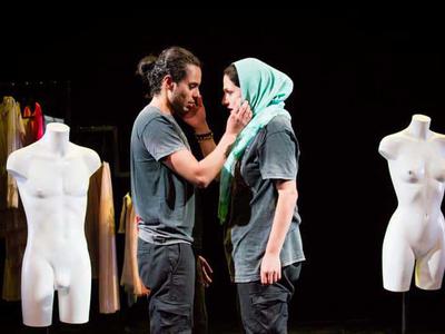 Glasgow Adam places his hand upon the cheek of his co-worker.