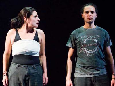 Egyptian Adam has her breasts wrapped. She looks at Glasgow Adam standing next to her.