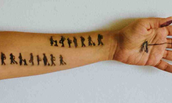 An arm with people drawn on it.