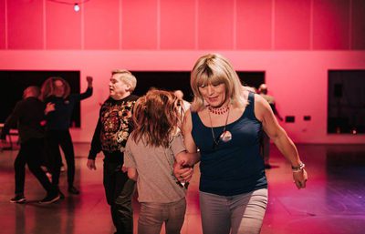 An adult and a child dancing together