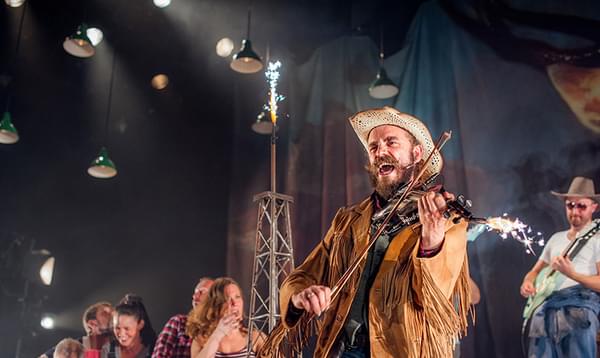 Aly Macrae playing the violin in a previous production of The Cheviot, The Stag and the Black, Black Oil.