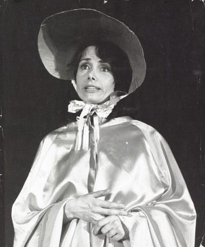 A black and white photo of a woman in a bonnet and silk shawl.