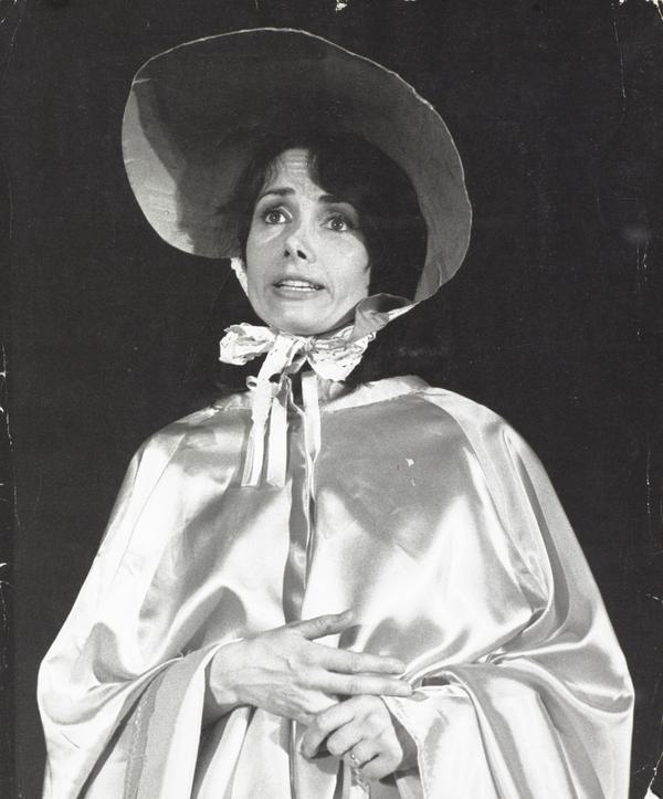 A black and white photo of a woman in a bonnet and silk shawl.