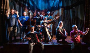 A group of performers playing instruments on the stage