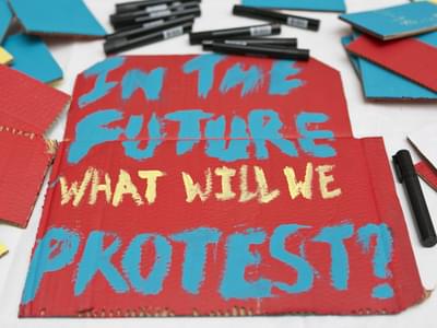 A sign that reads: In the future what will we protest?