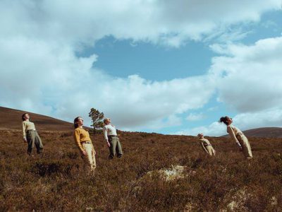 Five people leaning back in the hills