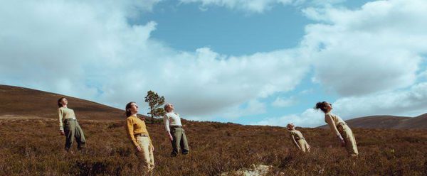 Five people leaning back in the hills