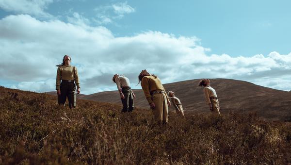 Five figures leaning backwards on a mountain