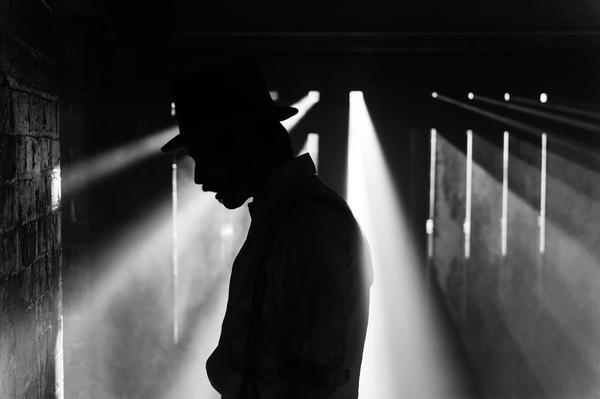 A man in a hat is silhouetted