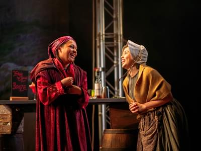 Two actors in period clothing chat