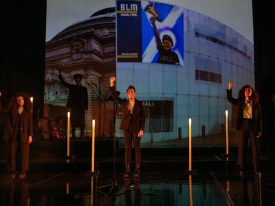 Three actors stand in solidarity