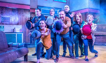The cast of My Left / Right Foot perform a musical number with hats.