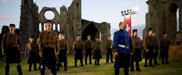 A group of men stand in the ruins of Elgin Cathedral.