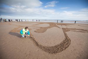artist group Sand in Your Eye creates large-scale sand portrait at West Sands Beach St Andrews