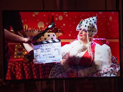 Paige Ootabook at the beginning of a take filmed in a red room with white polkadots