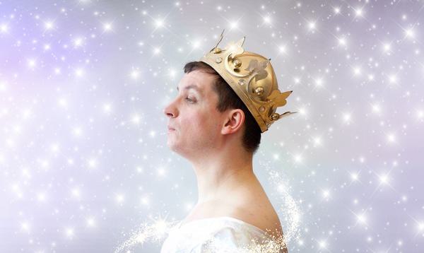 A person in profile wearing a crown and holding their chin up