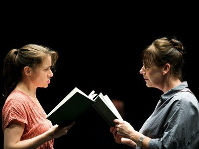 Shyvonne Ahmmad and Susan Vidler face each other, both holding a book.
