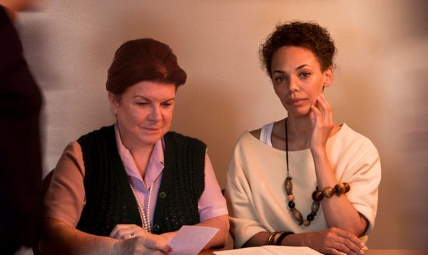 A black and white photo of the author Jackie Kay as a young woman sitting at a typewriter.