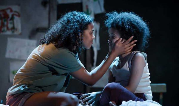 A mother puts both her hands on her young son's cheeks