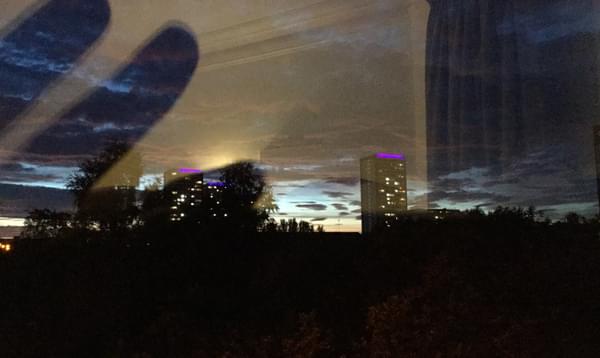 Photograph of a city skyline through a window