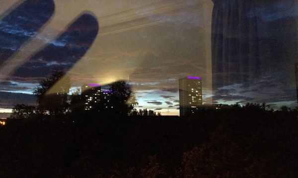 Photograph of a city skyline through a window