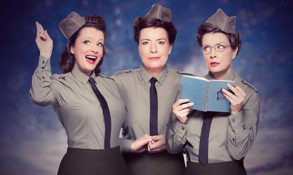Three women wearing military shirts, ties and caps.