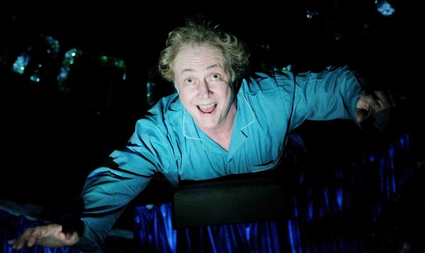 Man in blue night shirt grinning