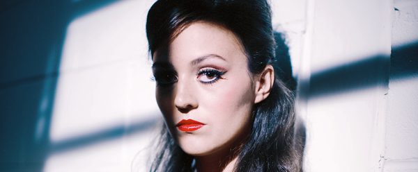 Portrait of a woman, her face partially obscured by shadow