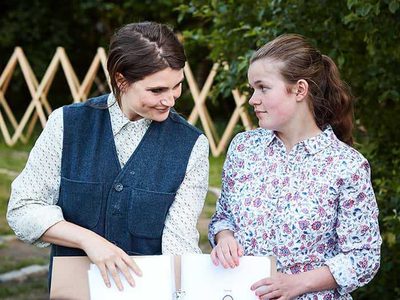 Two women showing a drawing