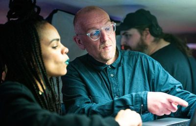 Two performers talking on set
