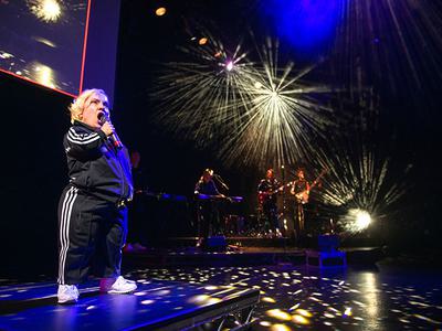 Kiruna sings with the band. She wears a black and white three stripe tracksuit