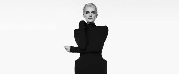 Black and white photo of Gayle Rankin. She wearing a black turtleneck dress.