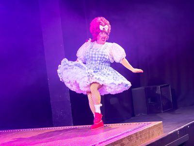 Johnny McKnight, a pantomime dame, is mid-dance. He swishes his skirt towards the audience and he is full of joy.